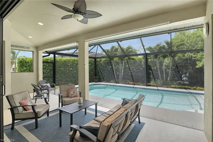 Outdoor pool with an outdoor living space, a ceiling fan, a lanai, and a patio