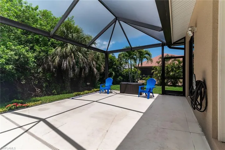 View of patio featuring a lanai