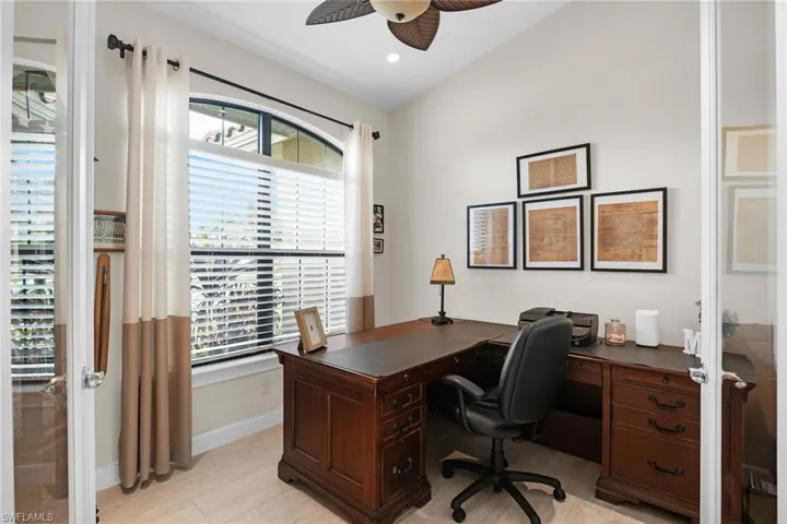 Office area with ceiling fan, baseboards, vaulted ceiling, and french doors