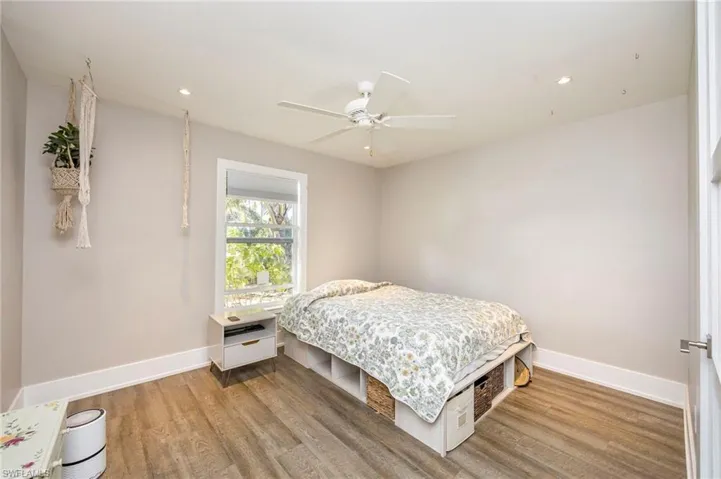 Bedroom with light wood-type flooring, ceiling fan, and recessed lighting
