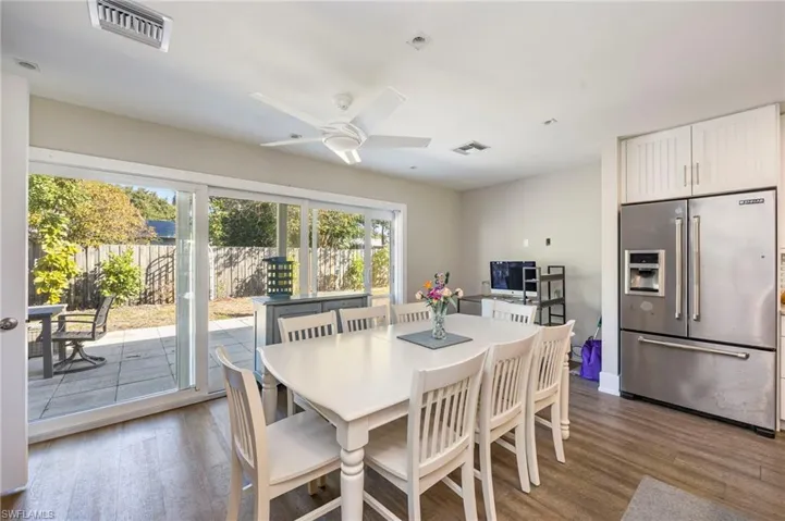 Dining space with wood finished floors and ceiling fan