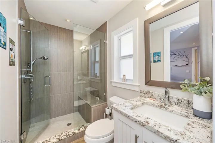 Bathroom featuring vanity, a stall shower, and recessed lighting