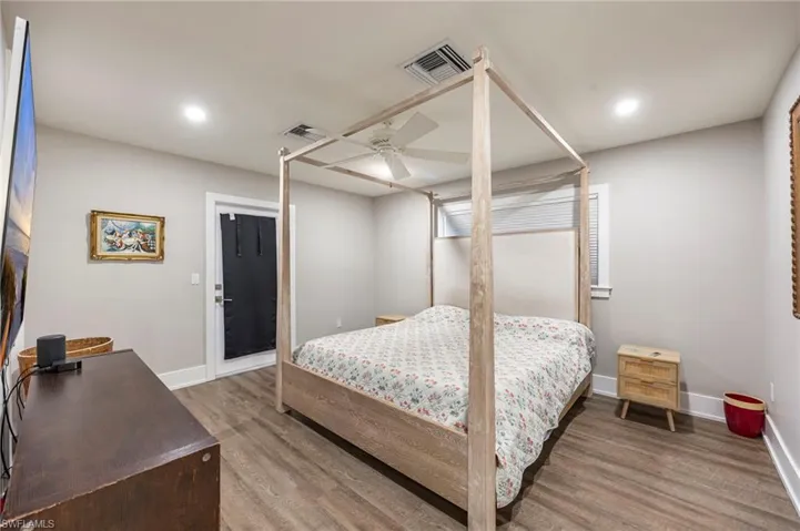 Bedroom featuring wood finished floors, a ceiling fan, and recessed lighting
