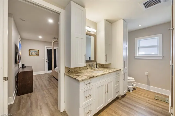 Bathroom featuring vanity, light wood-style floors, and connected bathroom