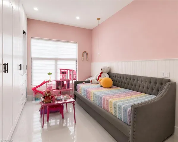 Room featuring extensive built-in white cabinetry, a large window with privacy blinds, and recessed ceiling lighting