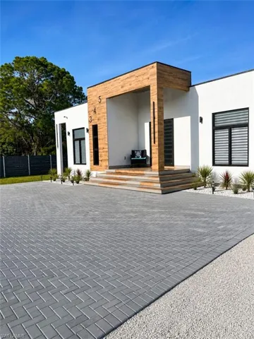 Contemporary facade featuring a prominent wood-finish entryway