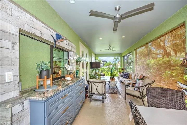 Sunroom featuring ceiling fan