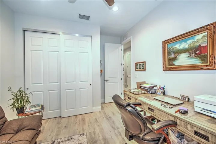 Home office featuring ceiling fan and light hardwood / wood-style flooring