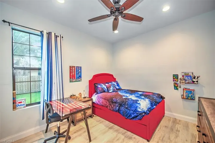 Bedroom featuring ceiling fan and light hardwood / wood-style flooring