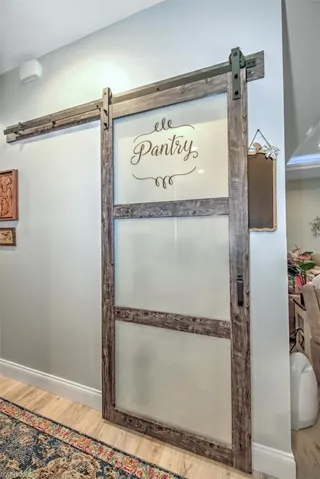 Details featuring wood-type flooring and a barn door