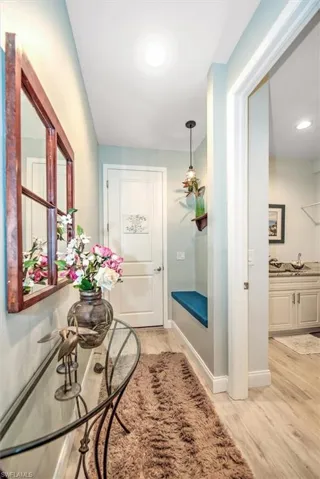 Doorway featuring bench and light hardwood / wood-style floors