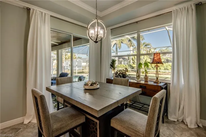 Dining room with crown molding and a chandelier