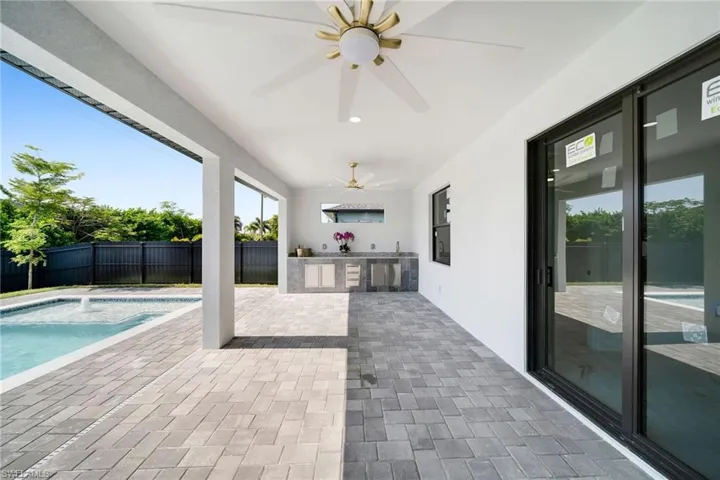 View of patio featuring ceiling fan, a fenced in pool, and area for grilling