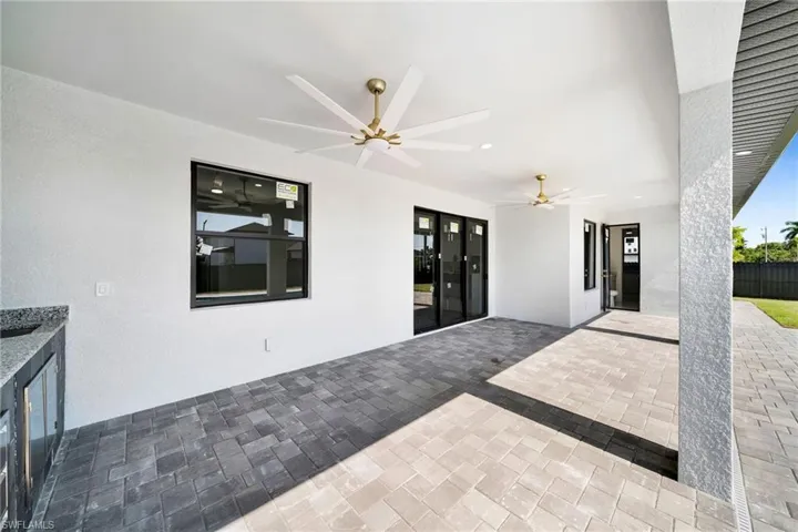 View of patio featuring ceiling fan