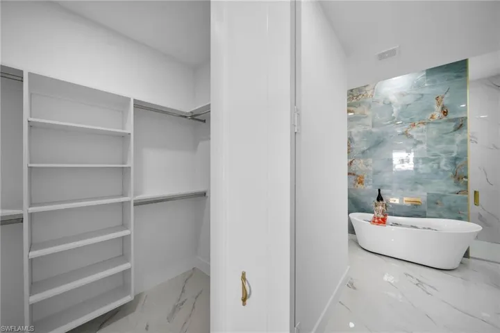 Spacious closet featuring tile floors