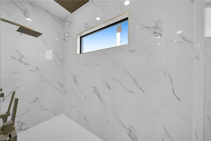 Interior details featuring a tile shower