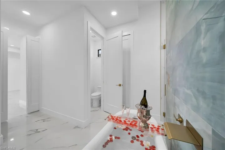 Bathroom with tile walls, tile floors, and toilet