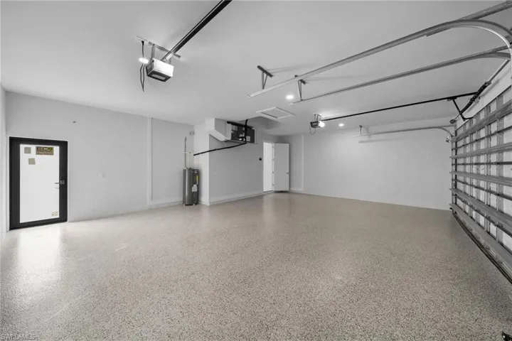 Garage with water heater and a garage door opener