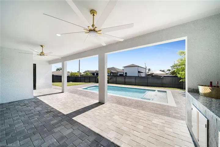 View of swimming pool featuring a patio and ceiling fan