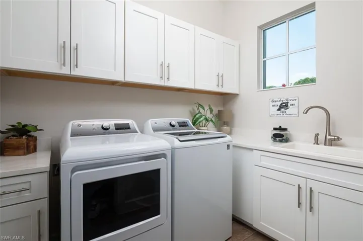 Laundry room featuring washing machine and dryer and cabinet space