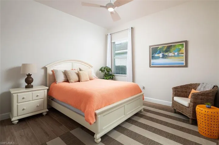 Bedroom featuring dark wood-style flooring and a ceiling fan