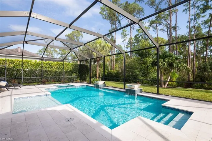 Swimming pool with a patio and a lawn