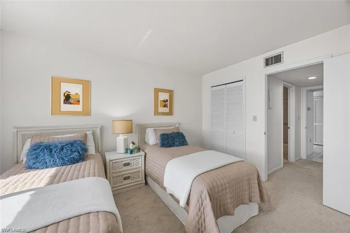 Carpeted bedroom with a closet and baseboards