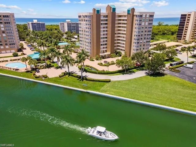 Aerial view of a large body of water and apartment complex / building