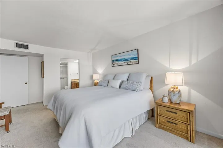 Bedroom featuring ensuite bath and carpet