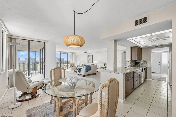 Dining room with expansive windows and light tile patterned floors