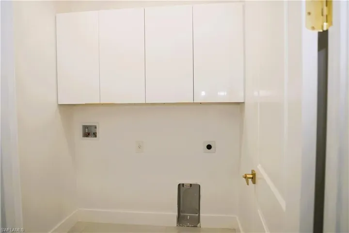 White flat-panel cabinetry with gold-tone hardware