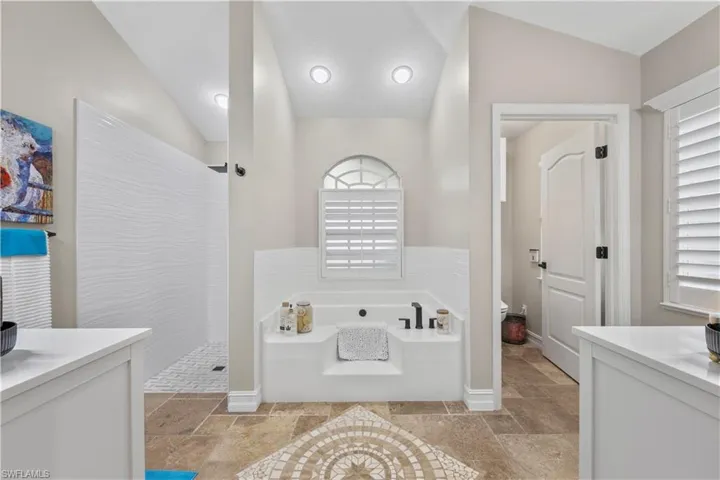 Renovated primary bathroom (Sept 2024) travertine flooring, separate bathtub and shower. Dual Sinks and private water closet