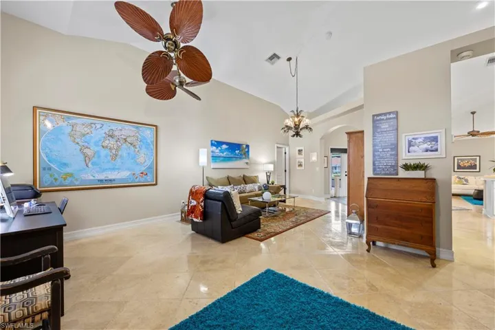 Living room at entrance of home. Travertine flooring throughout the home.