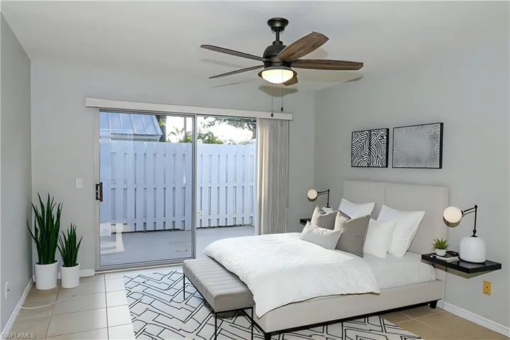 VIRTUALLY Staged Bedroom with access to exterior, light tile patterned floors, a ceiling fan