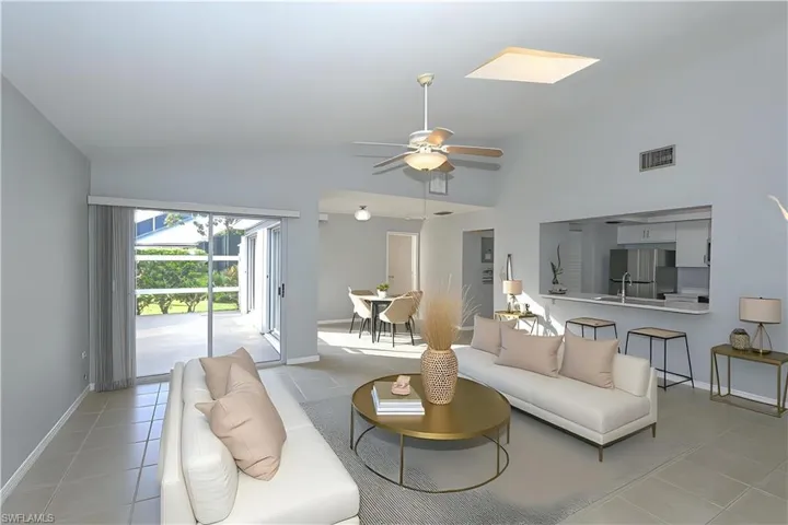 VIRTUALLY Staged View of the great room looking out to the patio