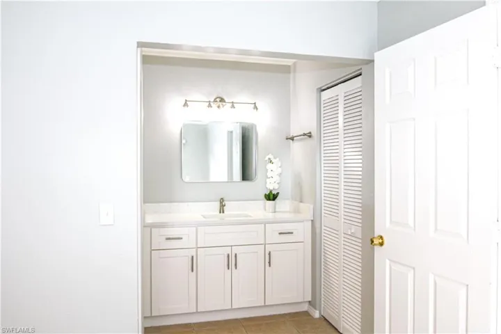 Bathroom featuring a quartz counter vanity