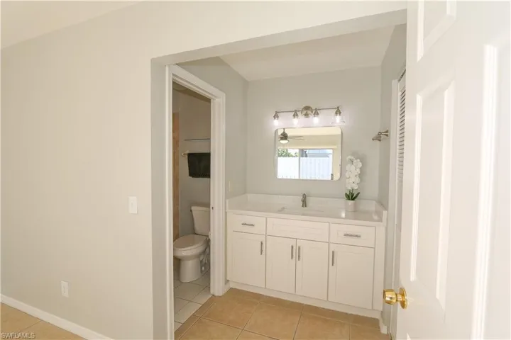 Bathroom featuring quartz counter vanity