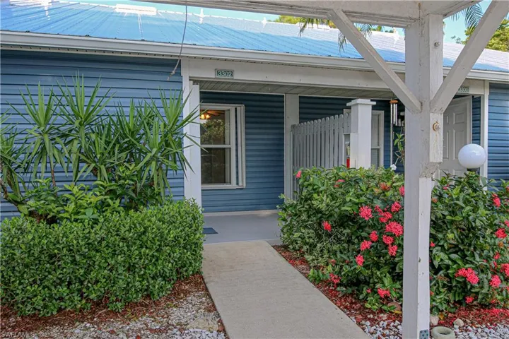 View of exterior entry with metal roof and a porch