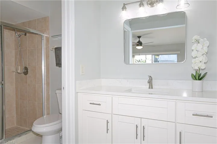 Bathroom featuring quartz counter vanity