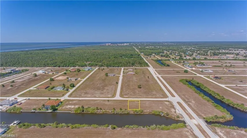 Bird's eye view of a nearby body of water and a heavily wooded area