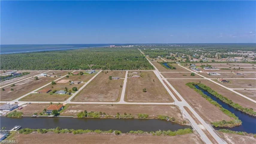 Aerial view of a large body of water and a heavily wooded area