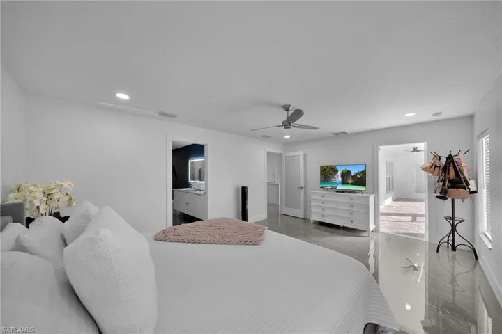 Bedroom featuring connected bathroom and ceiling fan