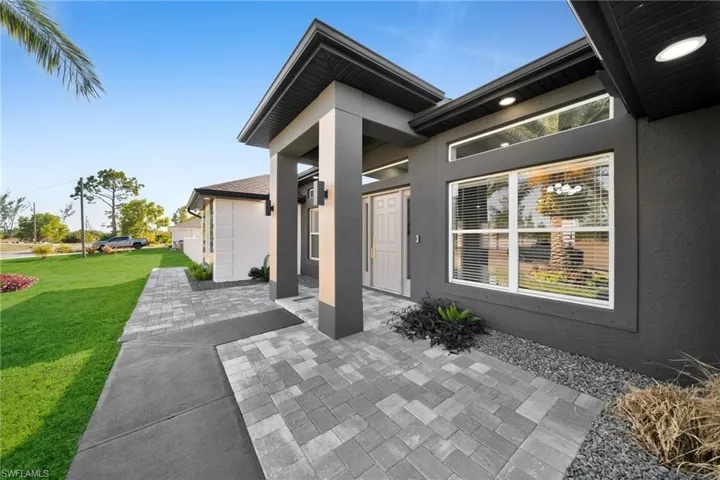 View of front of property featuring a garage and a front yard