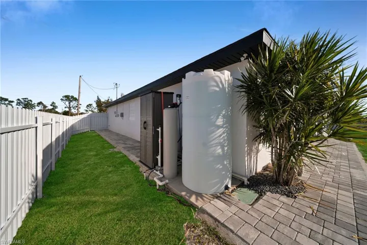 View of side of home featuring a yard