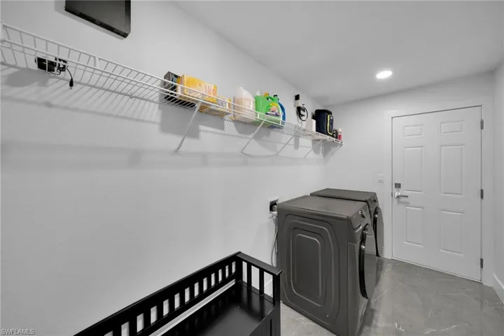 Clothes washing area featuring washer and dryer