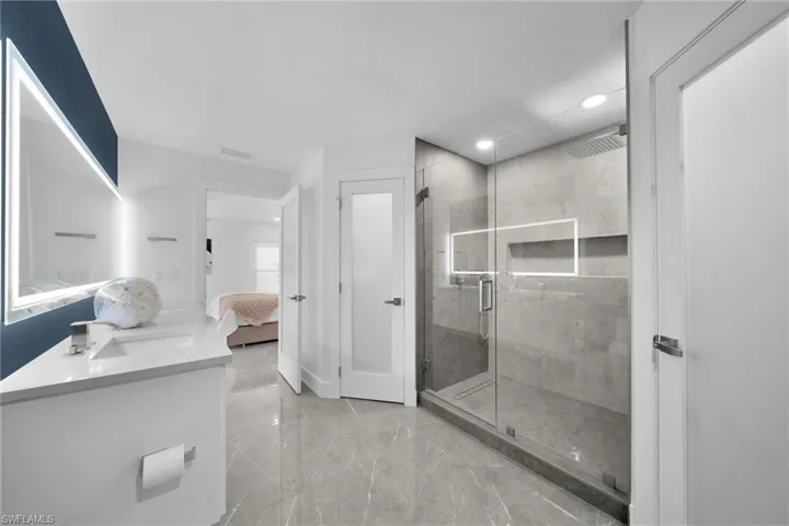 Bathroom with vanity and a shower with shower door