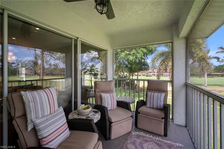 Sunroom featuring ceiling fan and a balcony