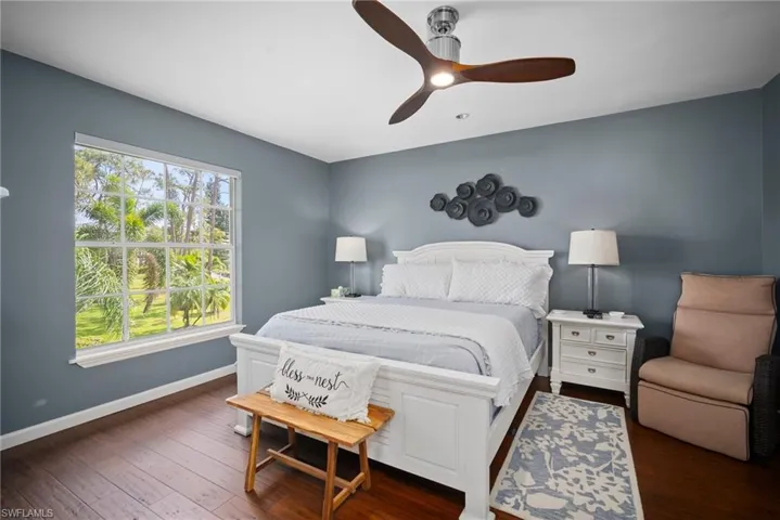 Bedroom featuring dark wood-type flooring and a ceiling fan