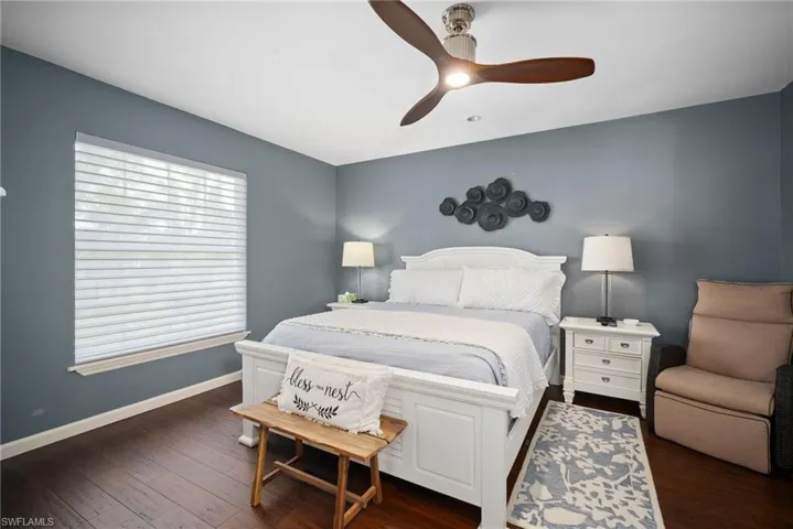 Bedroom with dark wood-style flooring and a ceiling fan