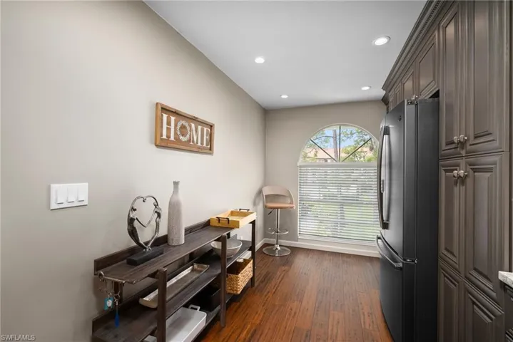 Home office featuring dark wood-type flooring and recessed lighting